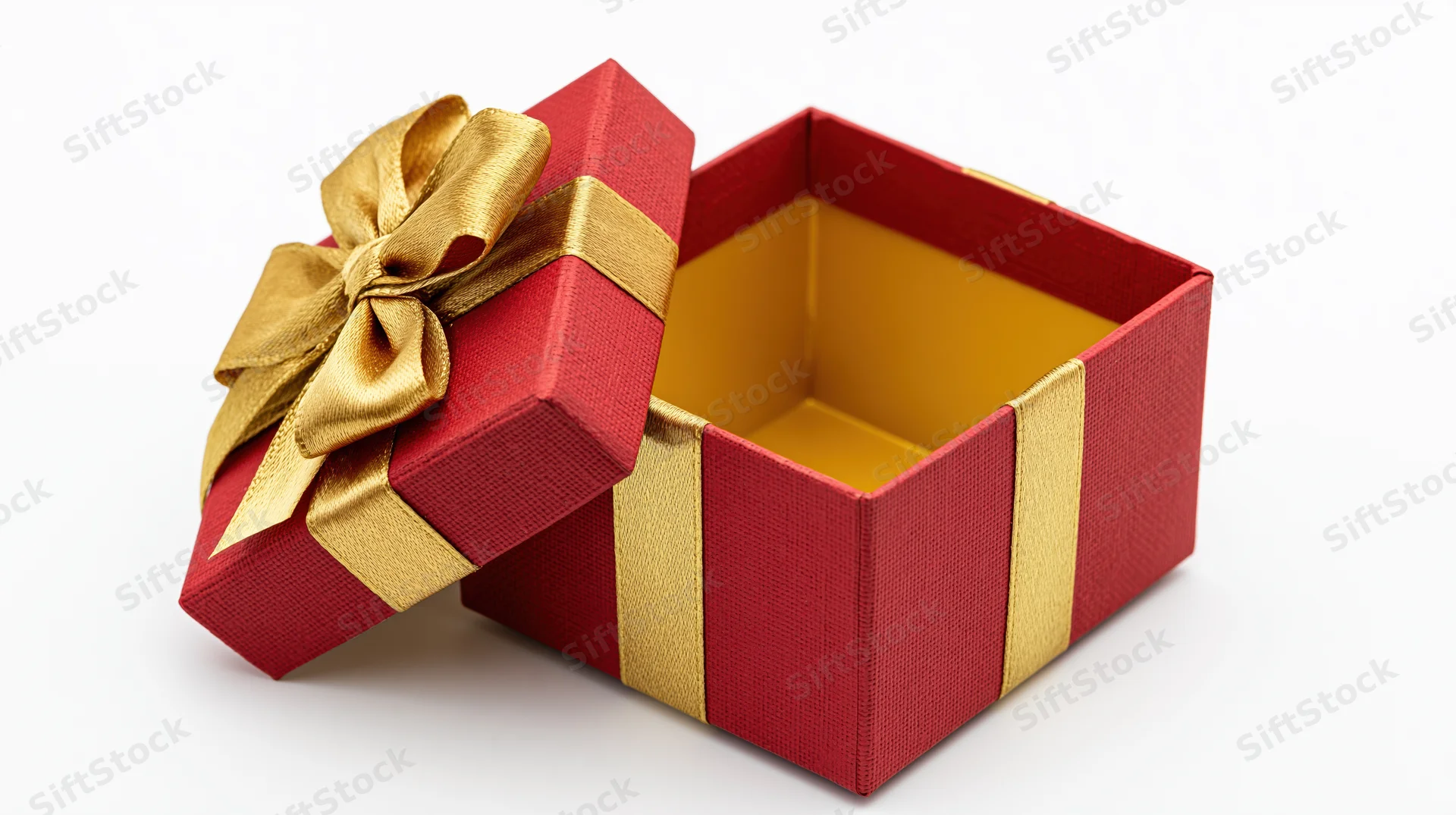 Open red gift box with gold ribbon and bow on white background