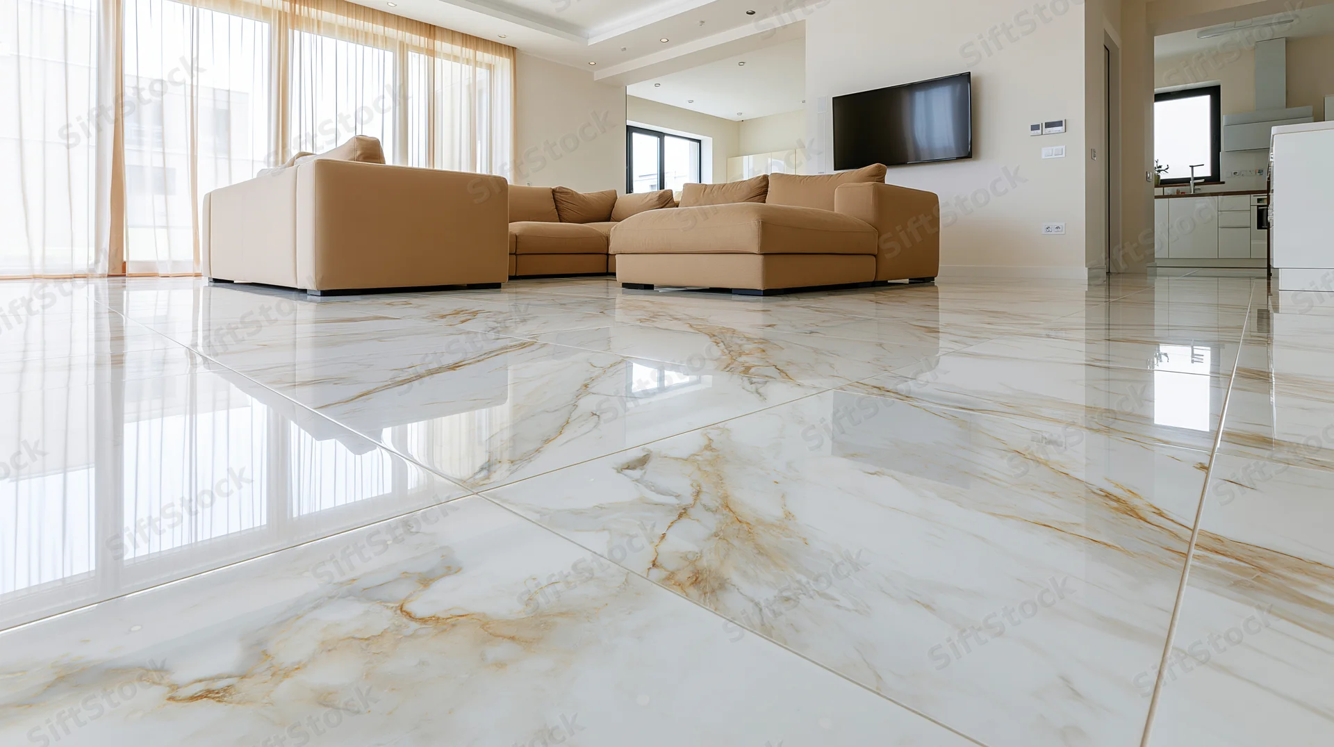 Spacious modern living room with polished white marble floors and beige sectional sofa near large windows