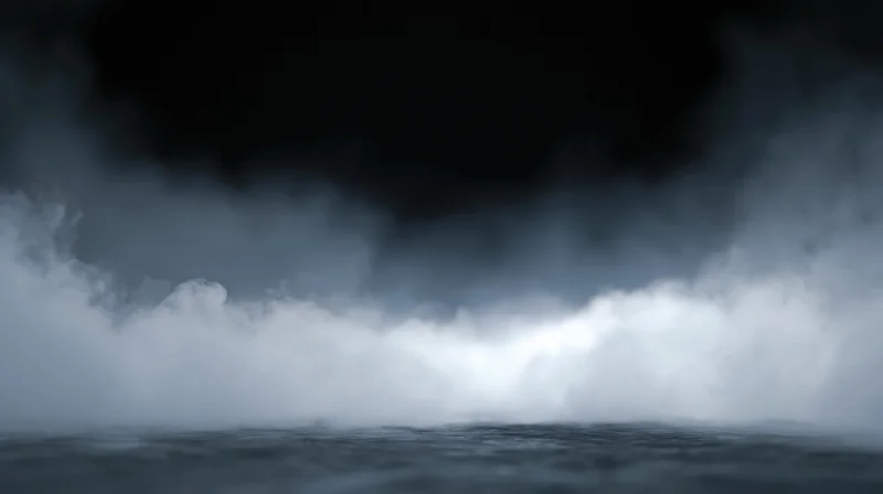 Thick white smoke rolling low across a dark studio floor