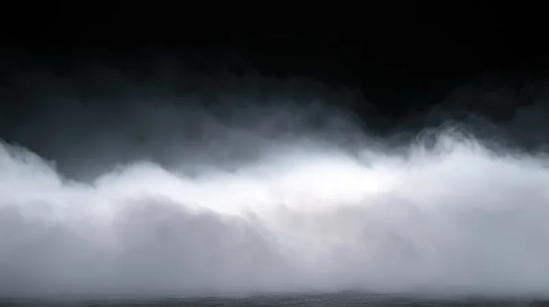 Thick white smoke rolling low across a dark studio floor