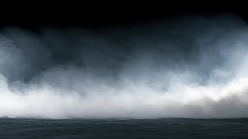 Thick white smoke and fog rolling low across a dark studio floor