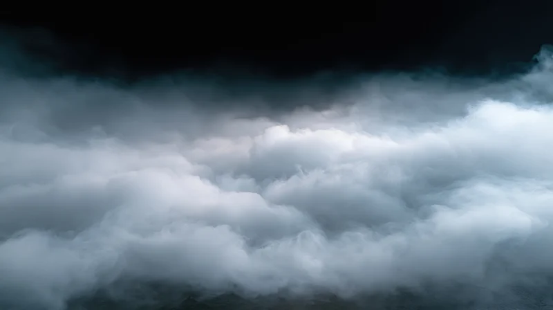 Thick white smoke and fog rolling low across a dark studio floor