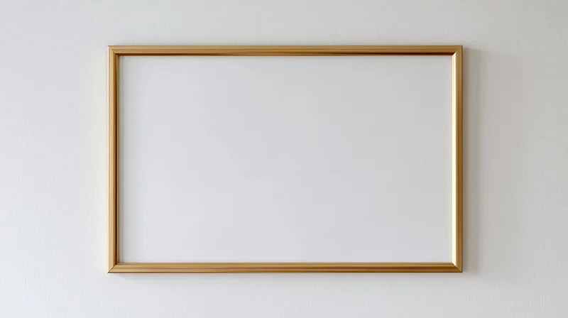 Thin gold metal picture frame with empty white interior hanging