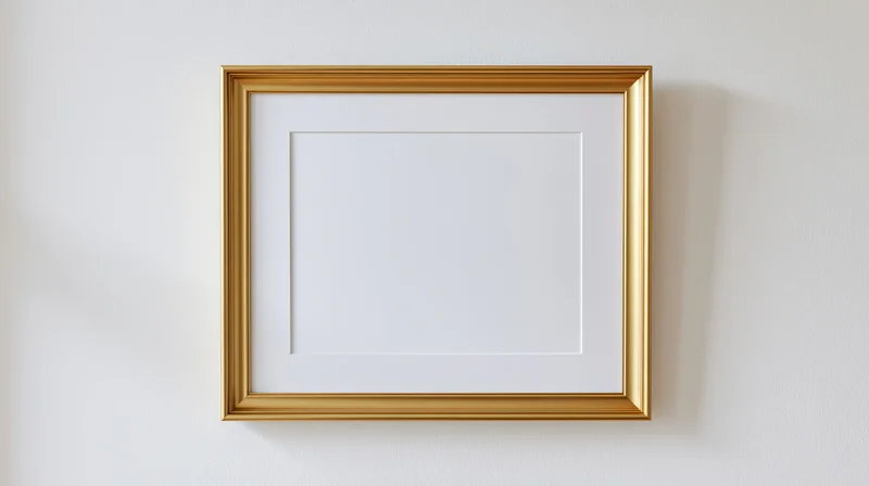 Gold picture frame hanging empty on white wall