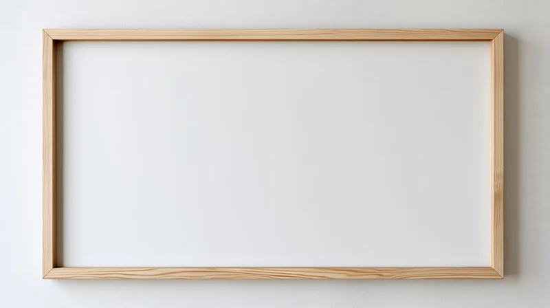 Thin natural wood picture frame hanging on plain white wall