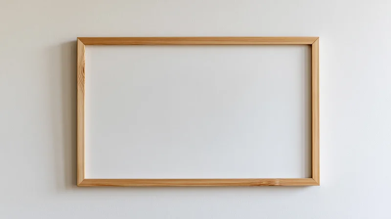 Thin natural wood picture frame hanging on plain white wall