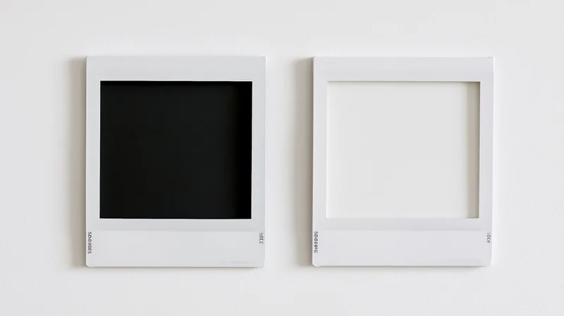 Two white polaroid photo frames side by side on a plain white wall