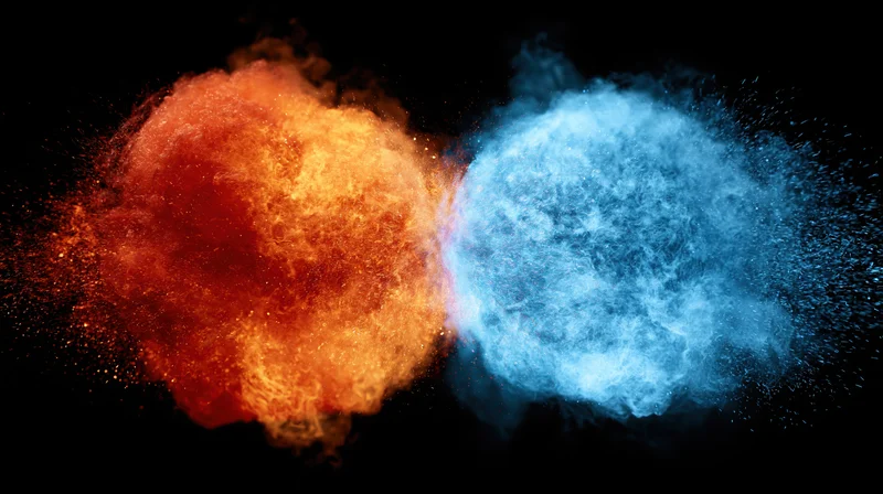 Orange and blue energy bursts colliding in mid-air against black background