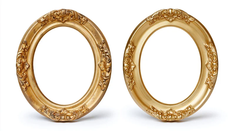 Two ornate oval gilded picture frames with baroque carved floral details on white background