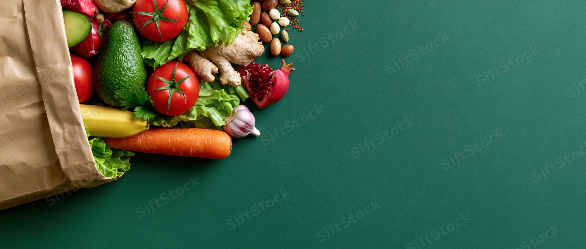 Brown paper bag spilling fresh vegetables and fruits on green surface