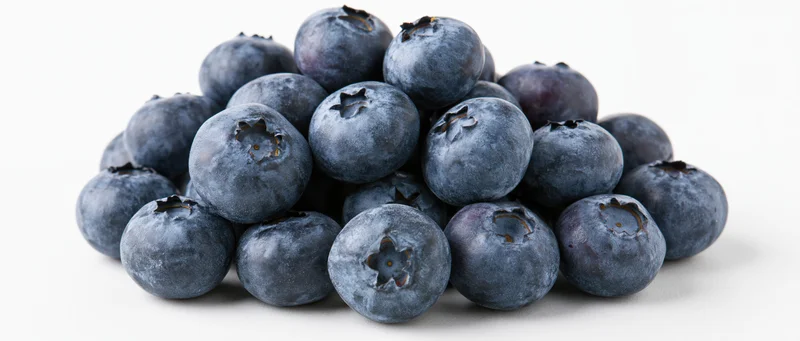 Pile of fresh blueberries on white background
