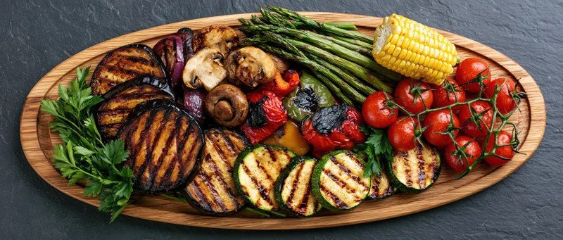 Assorted vegetables arranged on an oval wooden serving platter