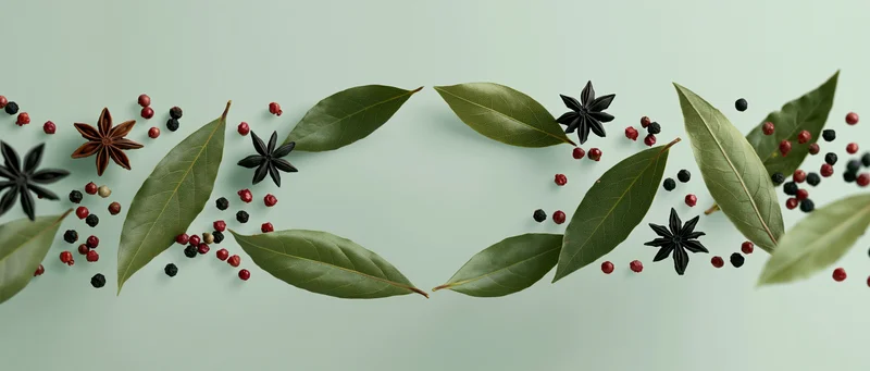 Bay leaves, star anise, and mixed peppercorns floating in midair against a light green background