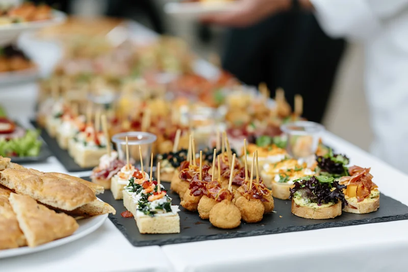 Assorted finger foods arranged on a buffet table at a social event