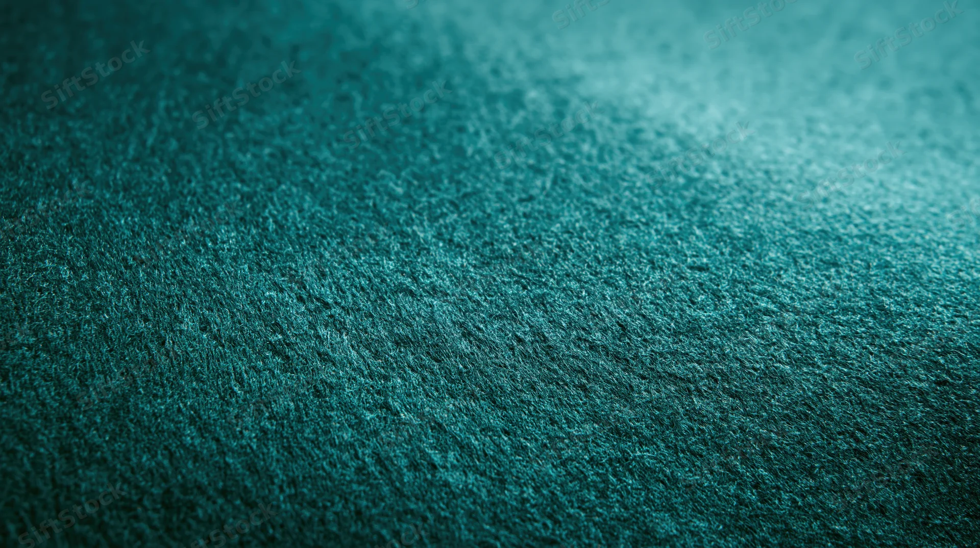 Close-up of deep emerald green felt fabric texture with soft lighting and gradient shadow