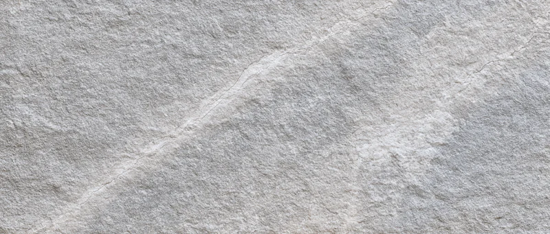 Close-up of natural grey stone surface with visible texture and veins filling the frame
