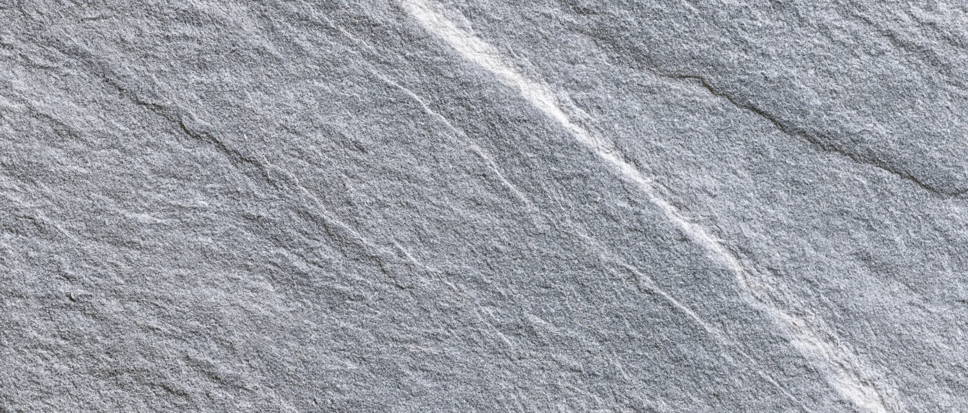 Close-up of natural grey stone surface with visible texture and veining