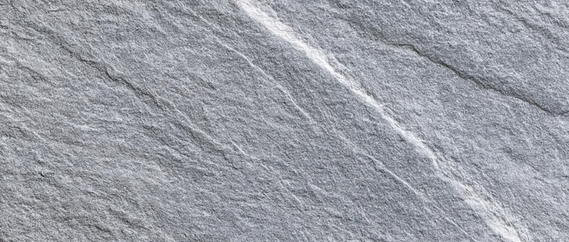 Close-up of natural grey stone surface with visible texture and veining