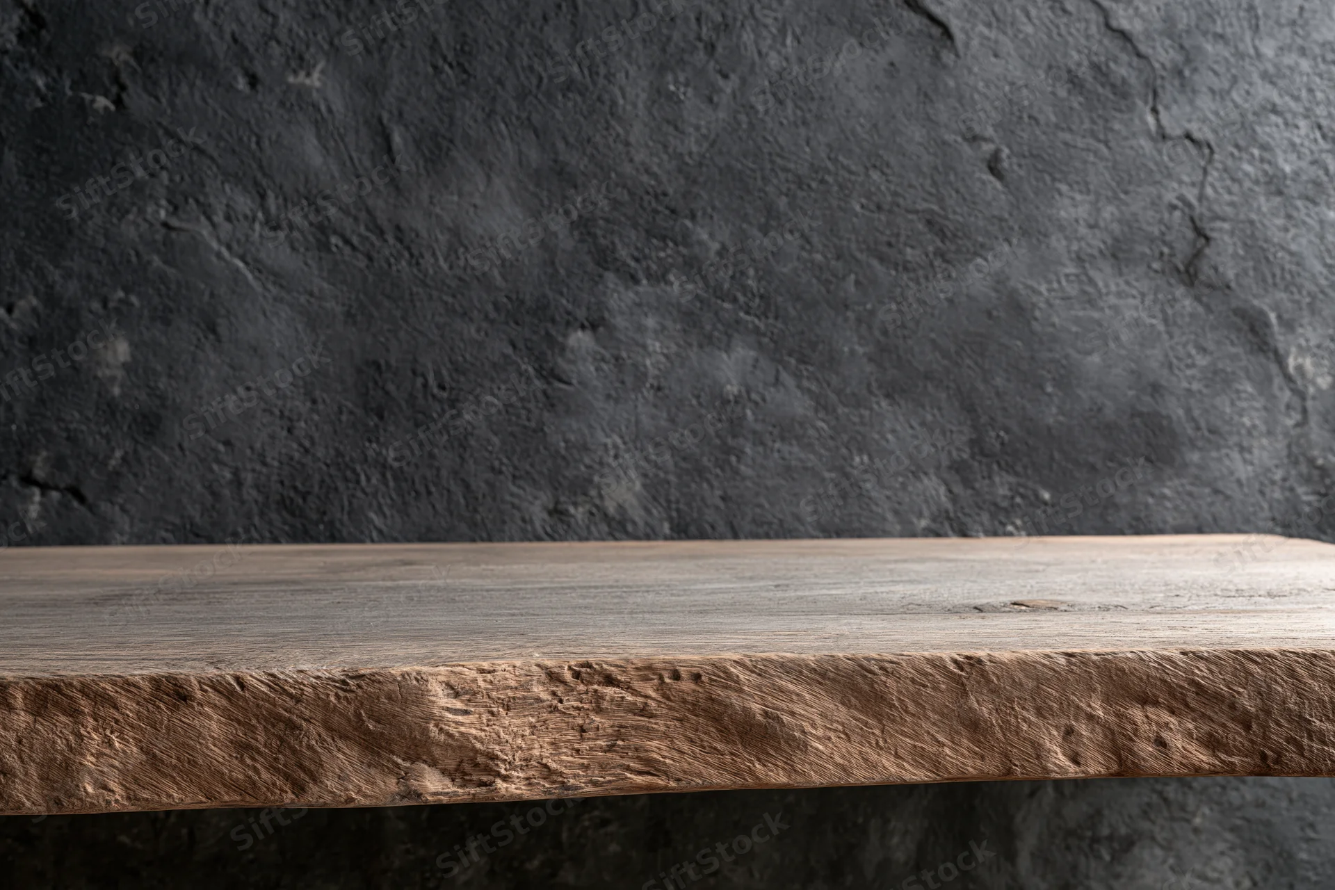 Weathered wooden shelf against dark textured concrete wall in interior space