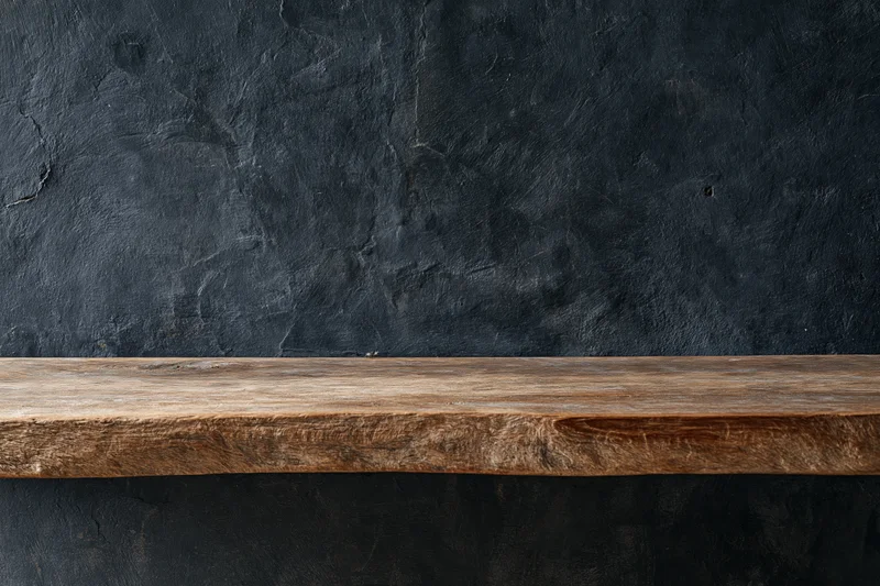 Weathered wooden shelf mounted against a dark textured wall in an interior space