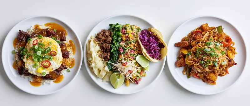 Three white plates with asian-inspired dishes arranged in a row on a white surface
