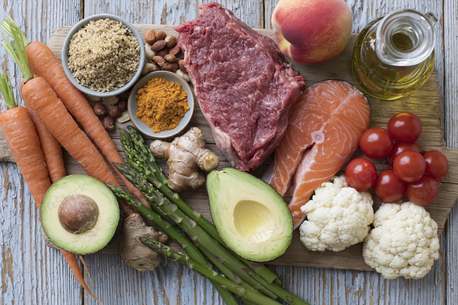 Variety of whole foods arranged on a wooden cutting board