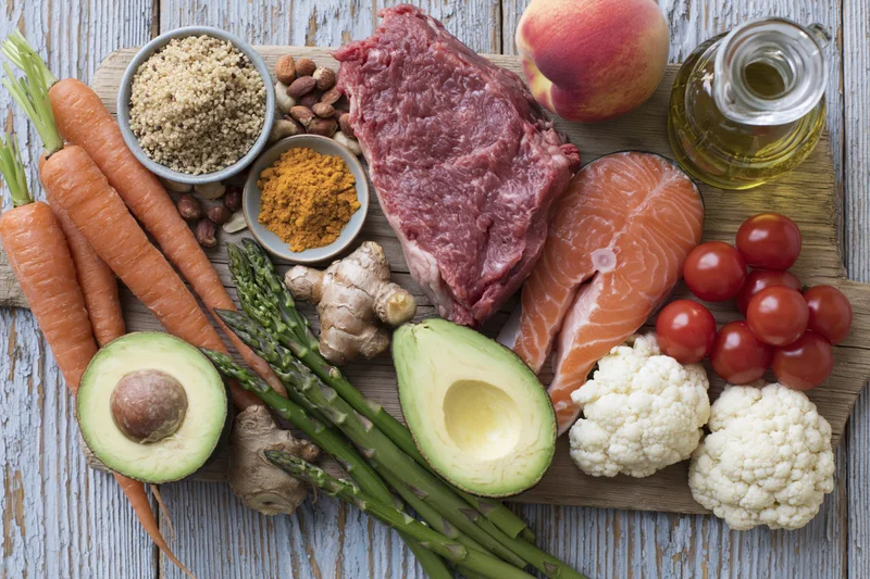Variety of whole foods arranged on a wooden cutting board