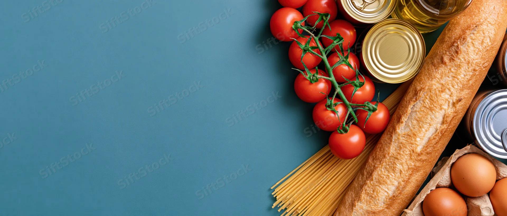 Grocery staples arranged along the right edge of a blue surface