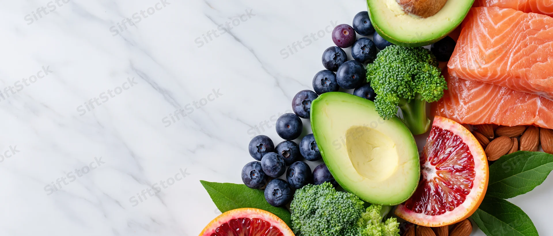Healthy foods arranged along the right edge of a marble countertop