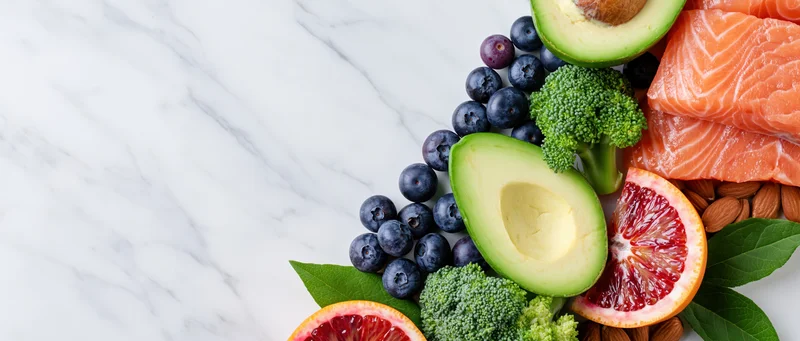 Healthy foods arranged along the right edge of a marble countertop