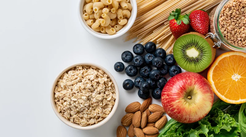 Healthy whole foods arranged in a flat lay on white surface with copyspace on left