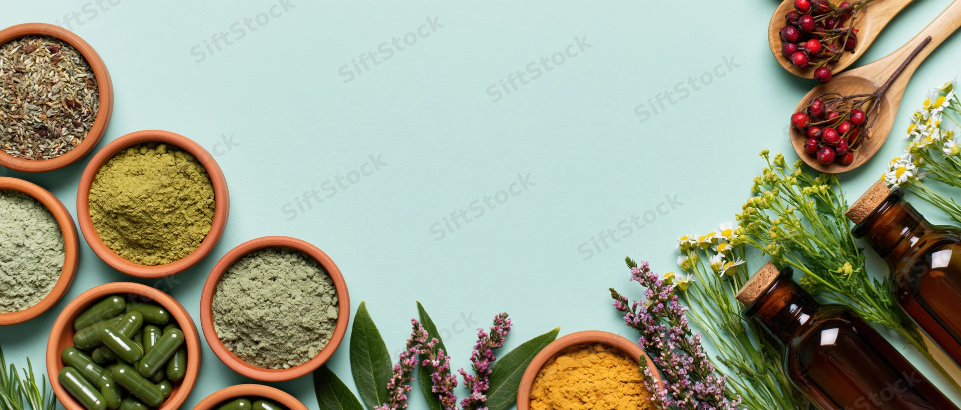 Herbal supplements and botanicals arranged in clay bowls and glass bottles on a light blue surface with copyspace