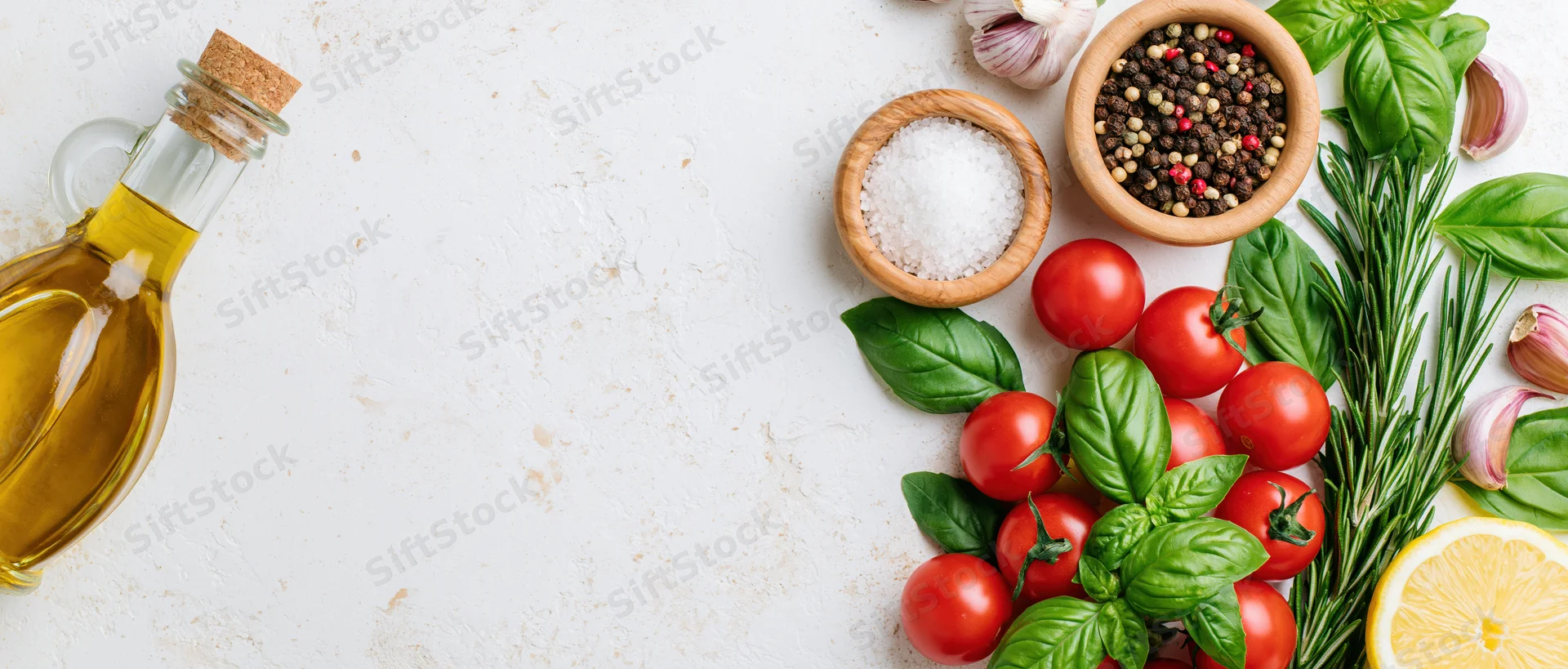 Fresh vegetables and herbs with olive oil and spices arranged on white surface