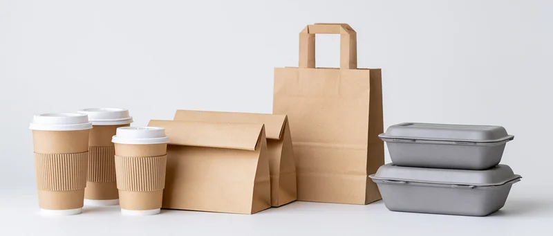 Kraft paper takeaway packaging arranged in groups on a white surface