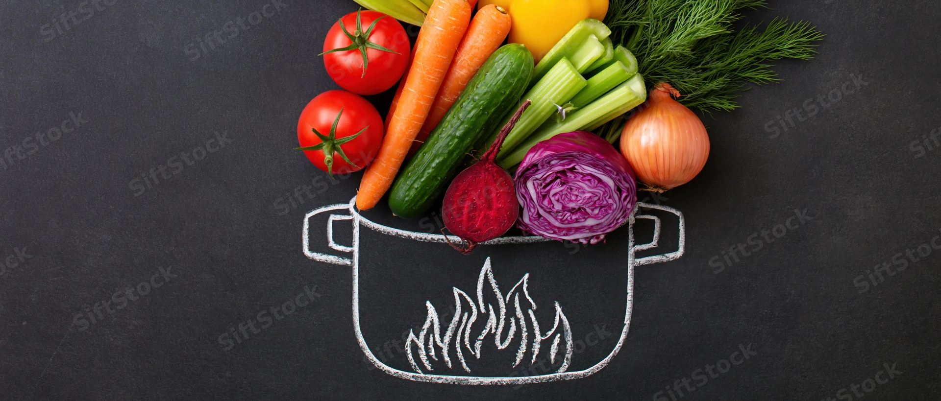 Fresh vegetables arranged in a chalk-drawn pot on a blackboard surface