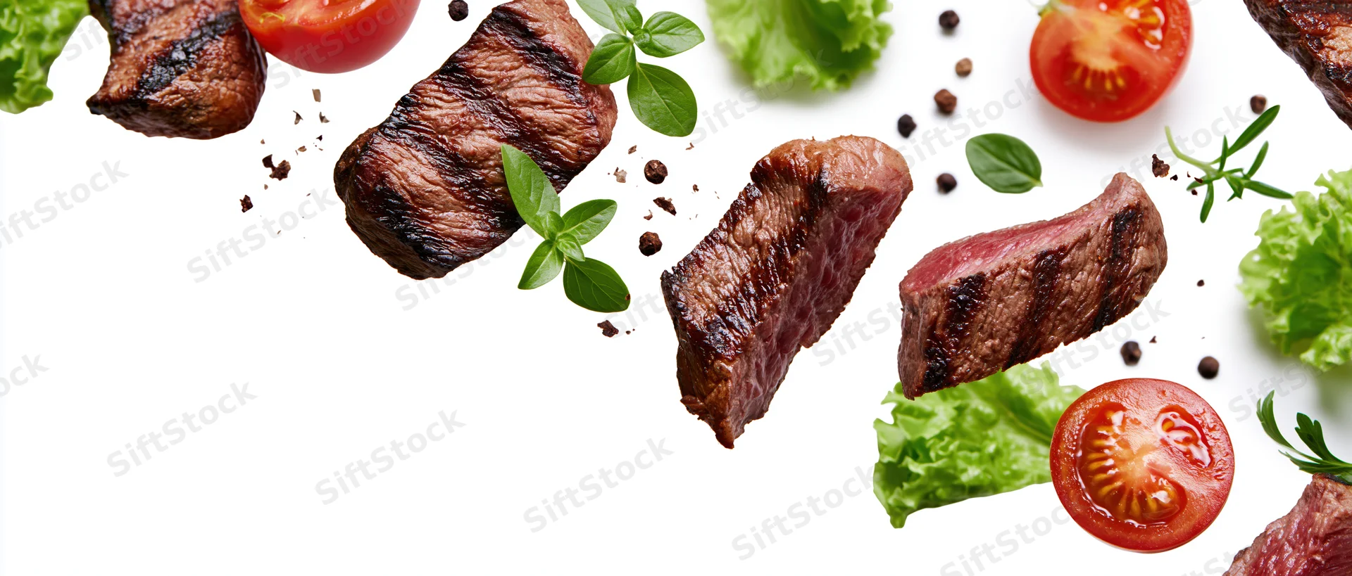 Grilled beef steak slices and fresh vegetables arranged in a flat lay on white background