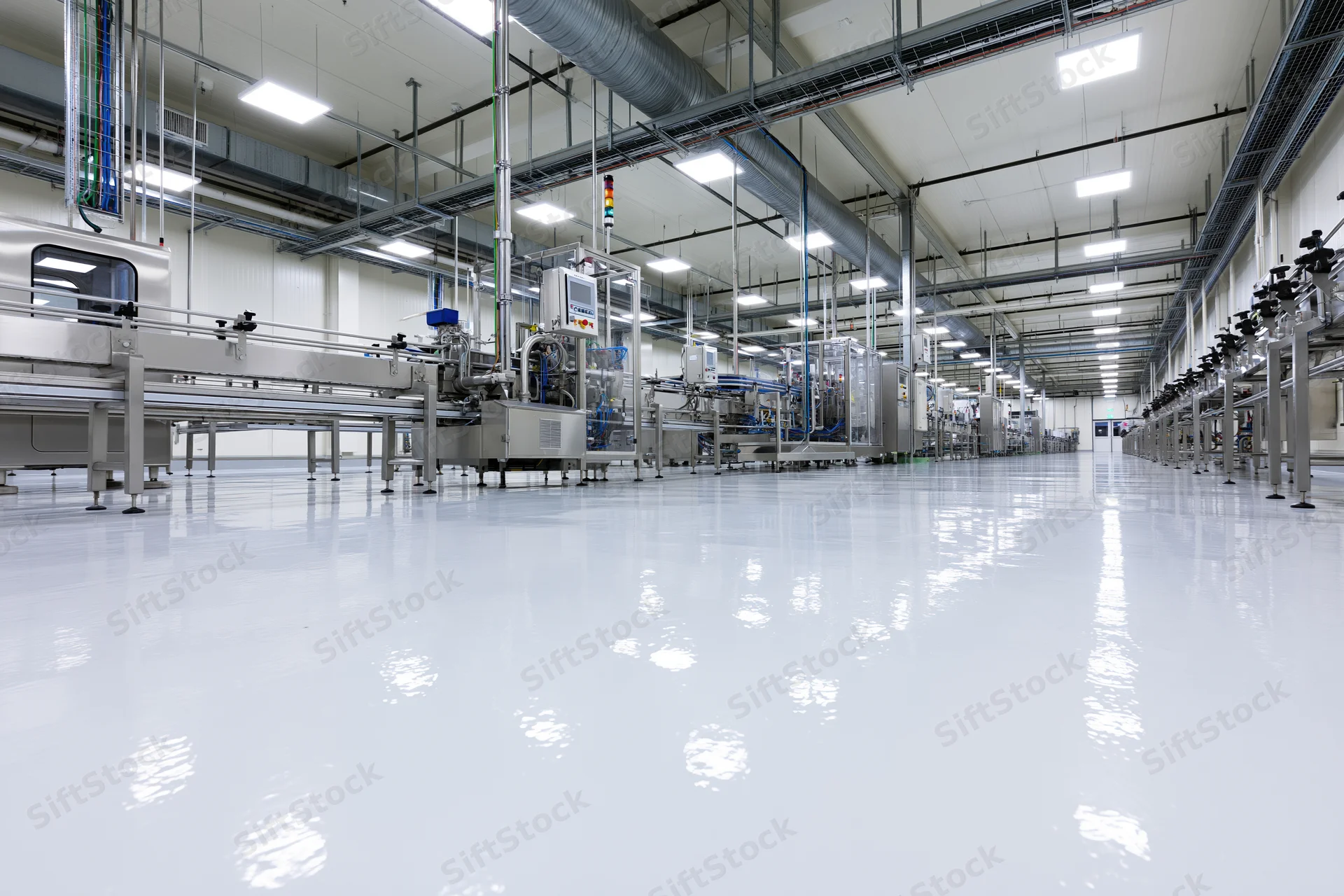 Interior of a modern food and beverage manufacturing plant with stainless steel machinery and automated production lines