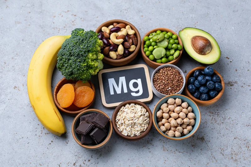Overhead flat lay of magnesium-rich foods arranged on a gray countertop