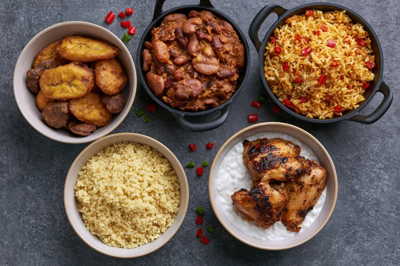 African cuisine dishes arranged in bowls on dark slate surface