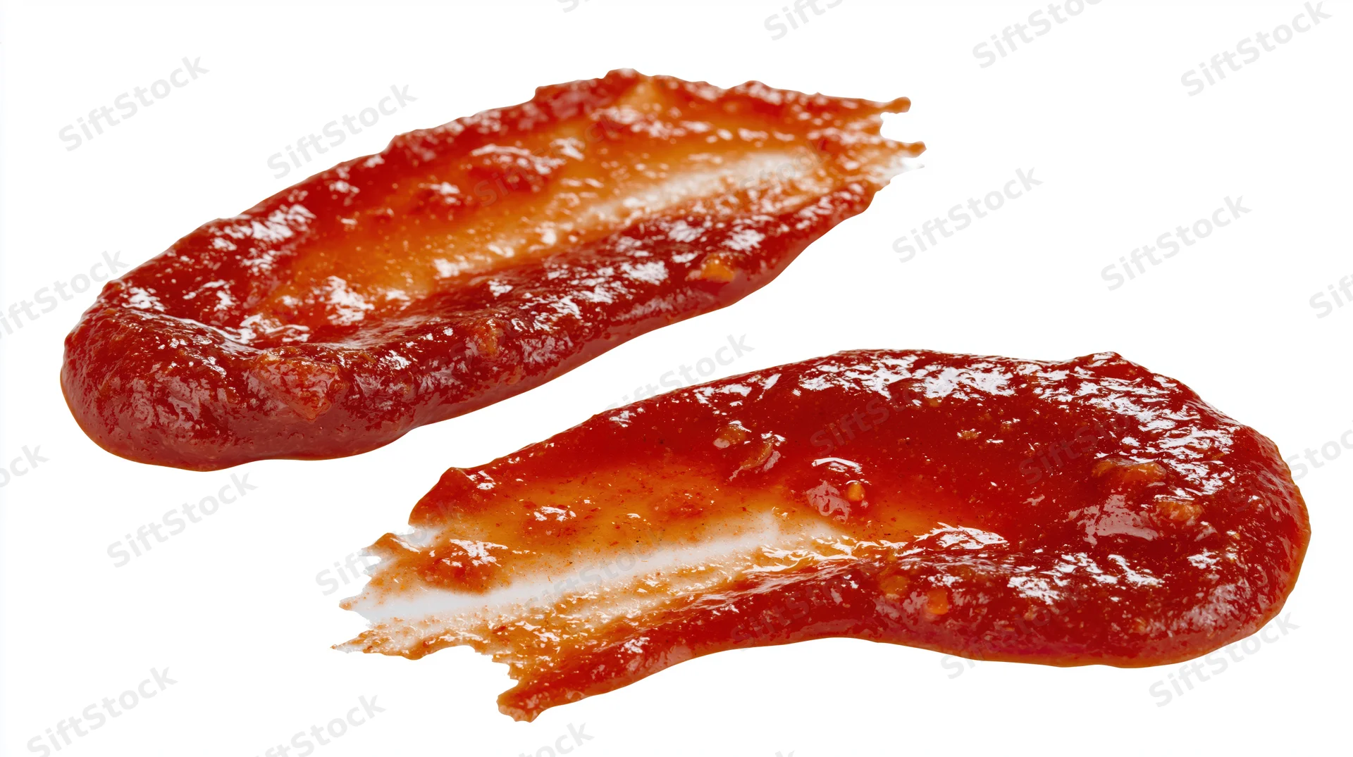 Two smears of red ketchup on a white background