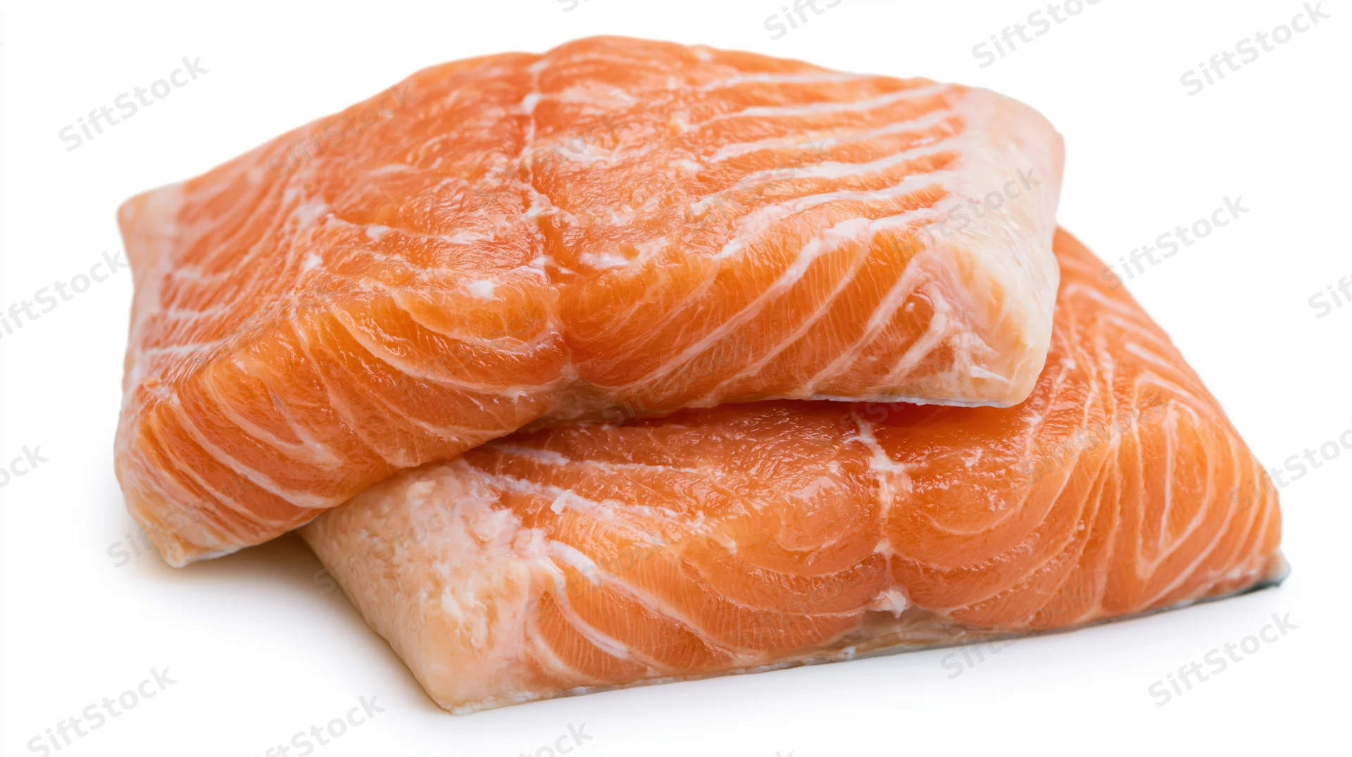 Two raw salmon fillets stacked slightly overlapping on white background