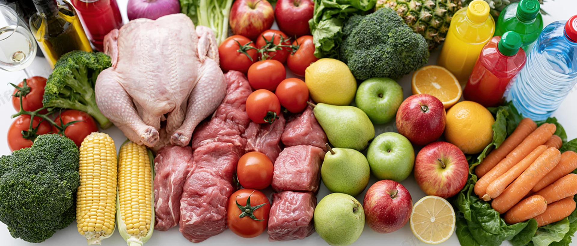 Mixed groceries arranged in a flat lay on a white surface