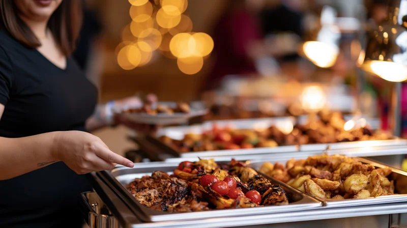 Woman serving herself from a buffet line at an indoor event