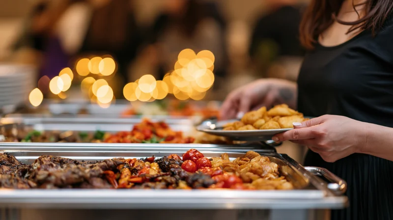 Woman serving food from a buffet line at an indoor event