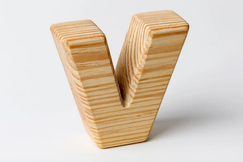 Wooden letter v block toy isolated on white background