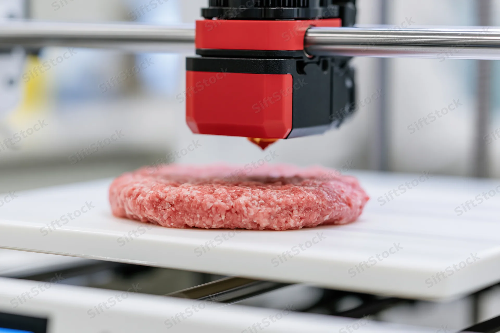 3d food printer extruding ground meat onto a white build plate in a lab setting