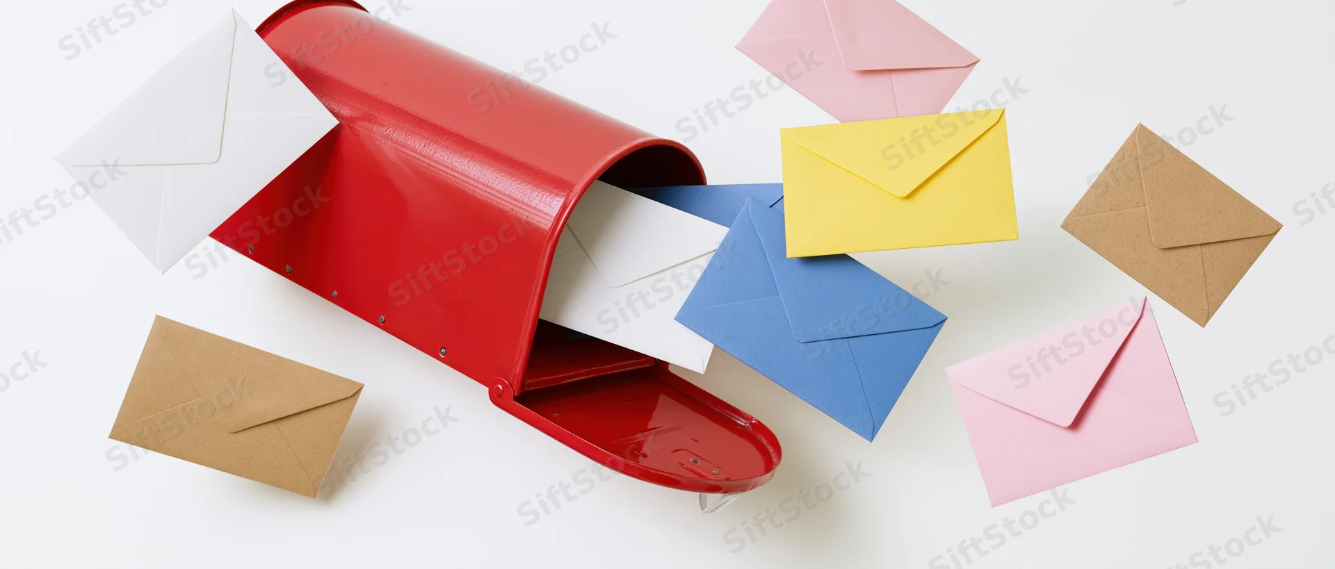 Red metal mailbox open with colorful envelopes scattered around on white background