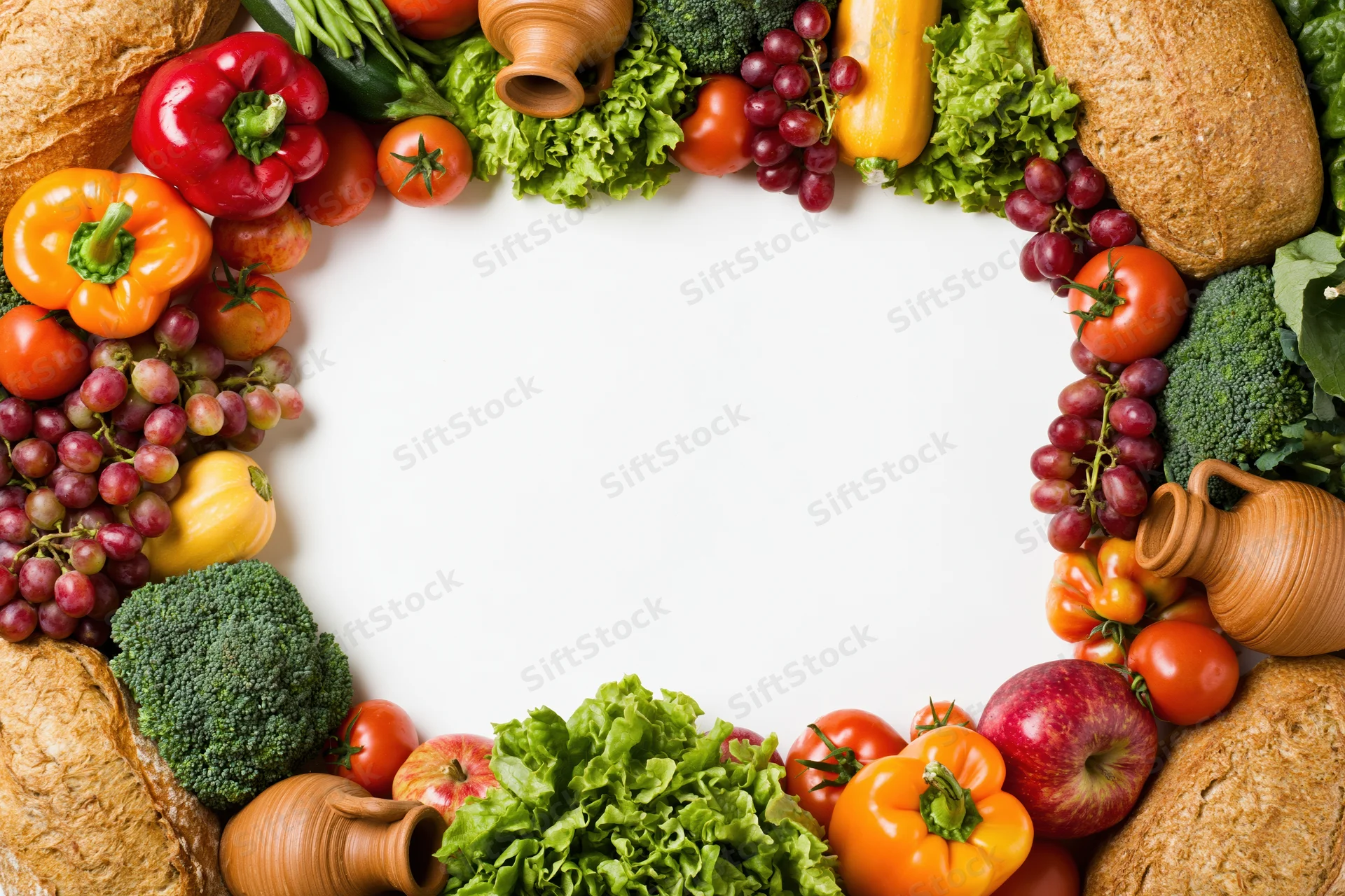 Fresh fruits and vegetables arranged in a border frame around a white center
