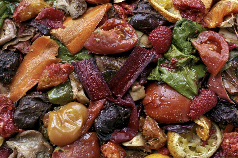 Close-up of mixed vegetable and fruit scraps piled together in a heap