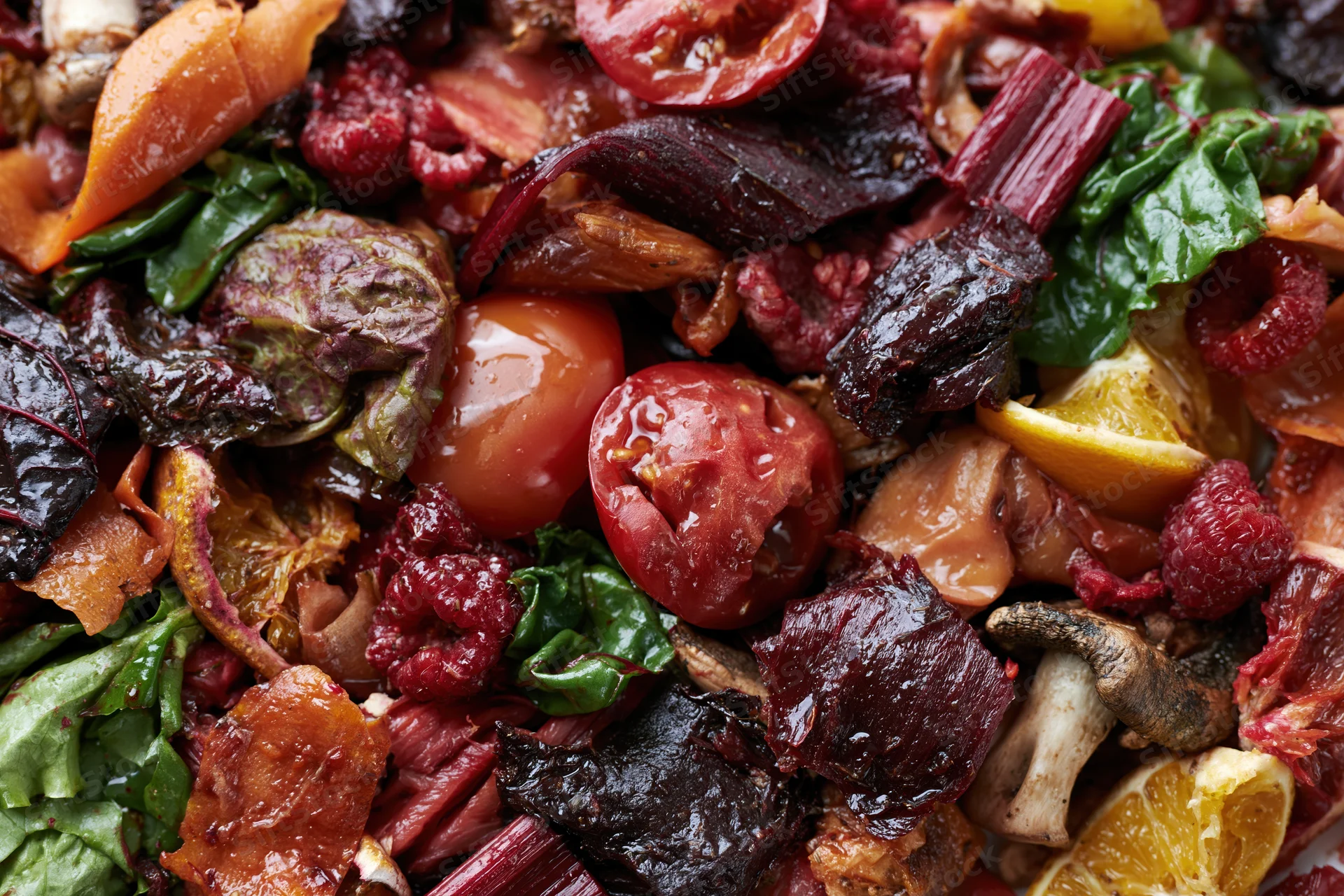 Close-up of mixed vegetable and fruit scraps piled together for composting